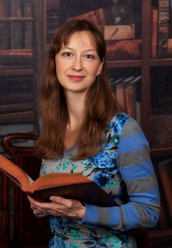 Woman holding an open book with Russian title: Орфоэпический словарь русского языка.